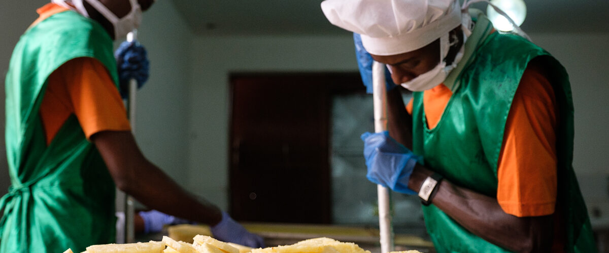 The workers remove the pineapple hearts and arrange the slices on a tray